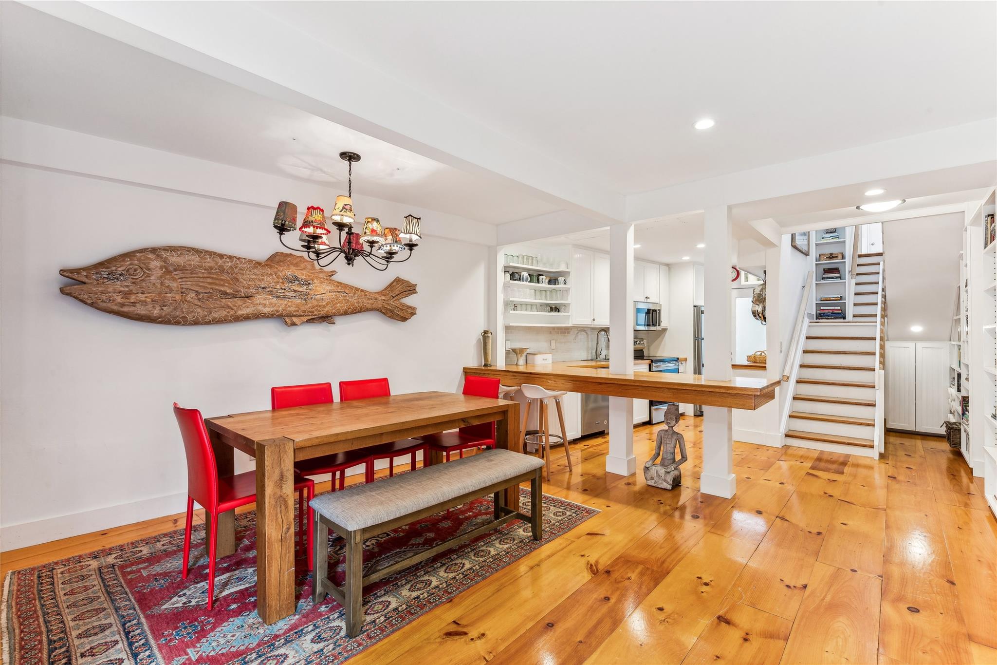 Dining room featuring baseboards, stairs, light wood-type flooring, recessed lighting, and an inviting chandelier