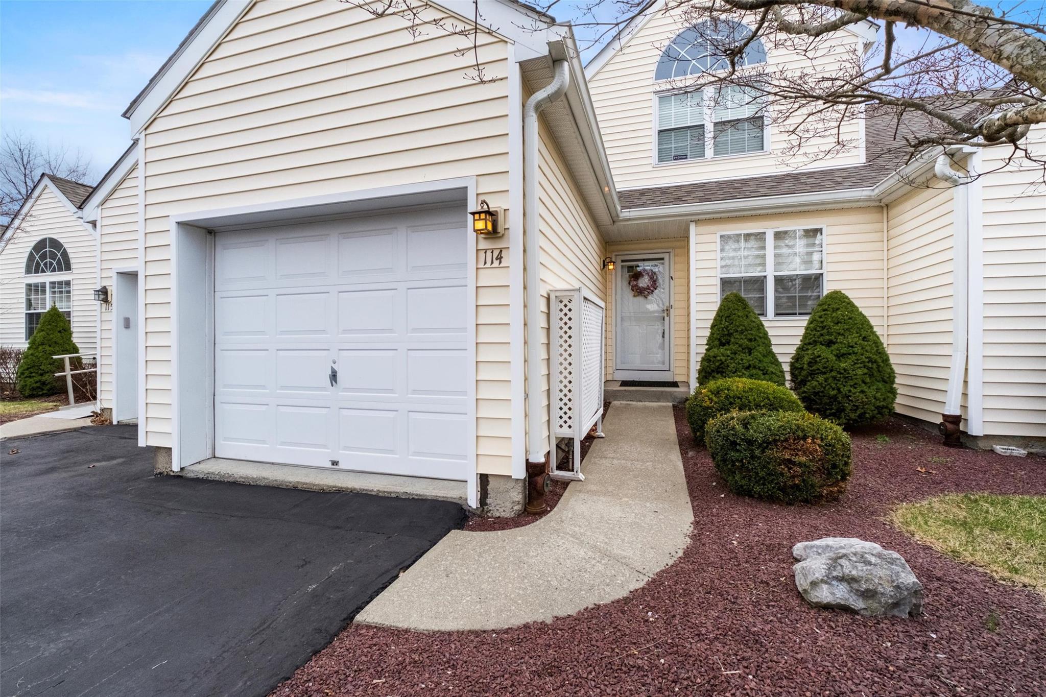 View of front of property with driveway and an attached garage