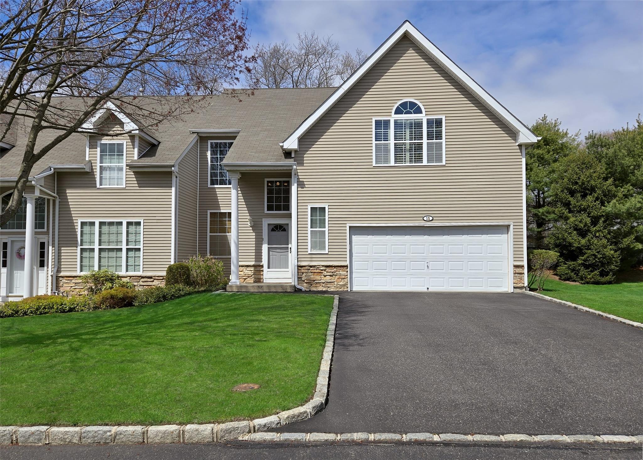 Attached 2 car garage & cobblestone lined Blacktop driveway