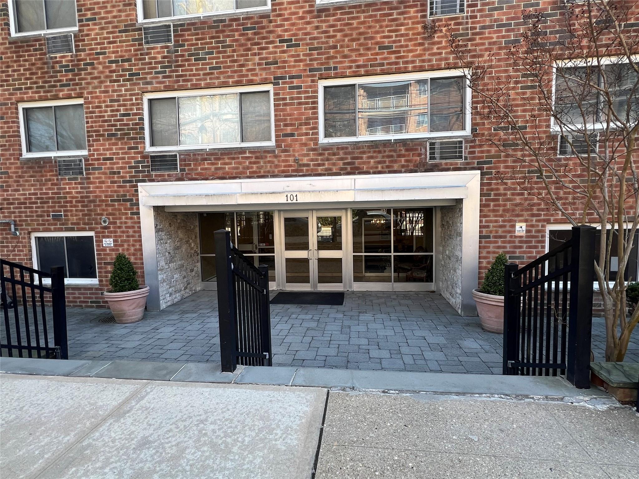 View of exterior entry featuring brick siding