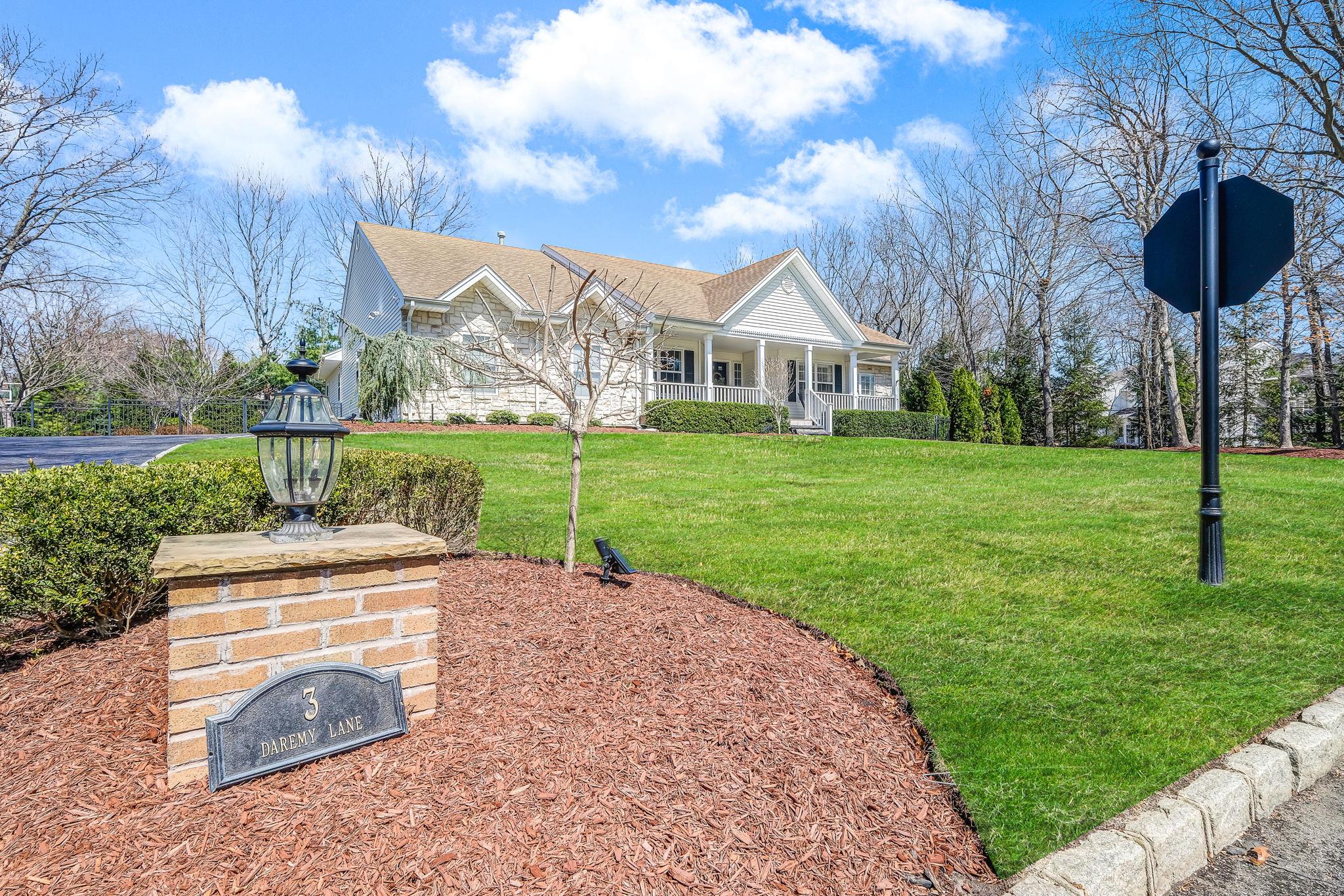 View of front of house with a front yard and covered porch