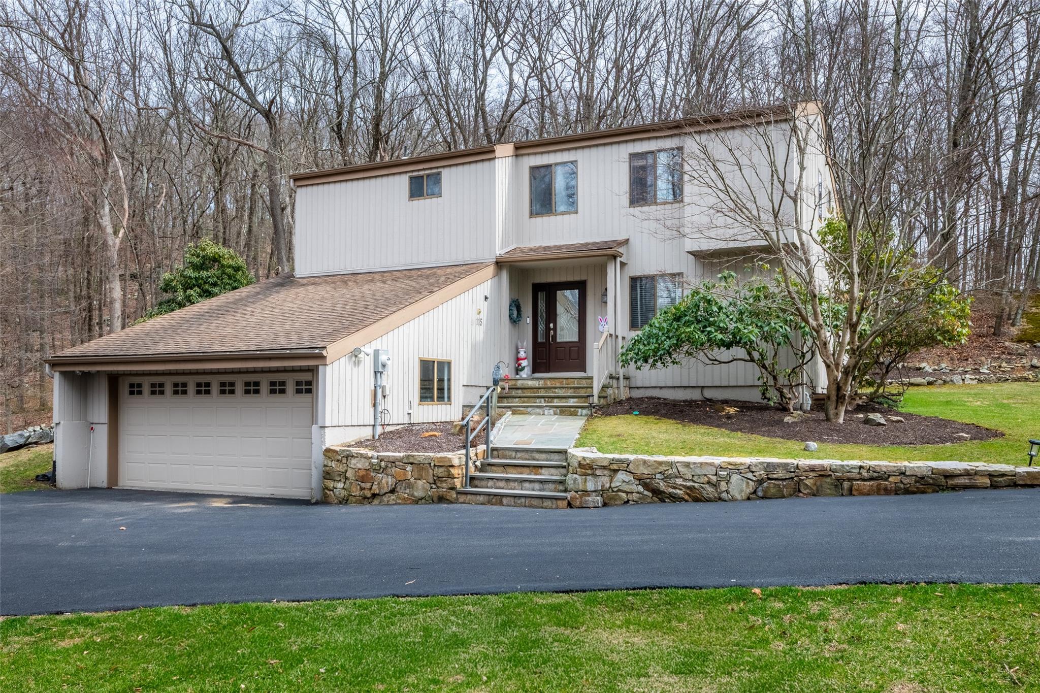 View of front of home with driveway and an attached garage