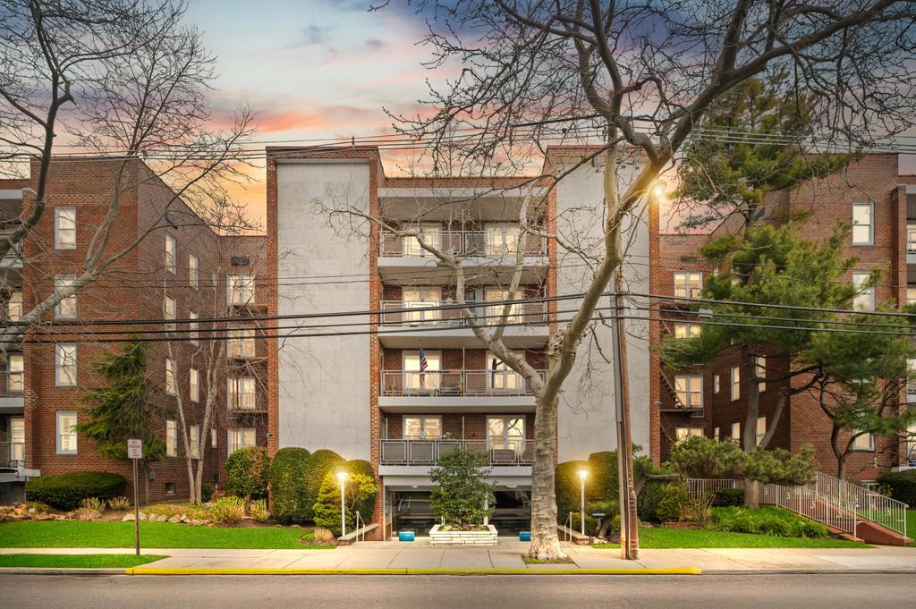 View of property at dusk