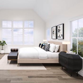 Bedroom featuring multiple windows, wood finished floors, and lofted ceiling