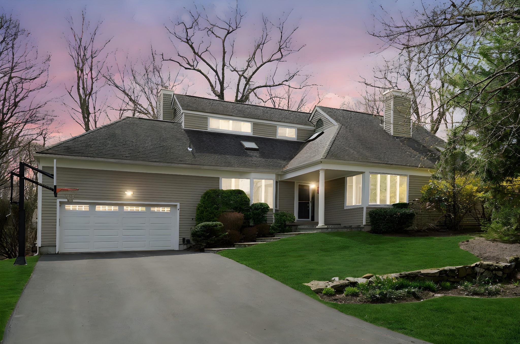 Street view of front house with a 2 car attached garage