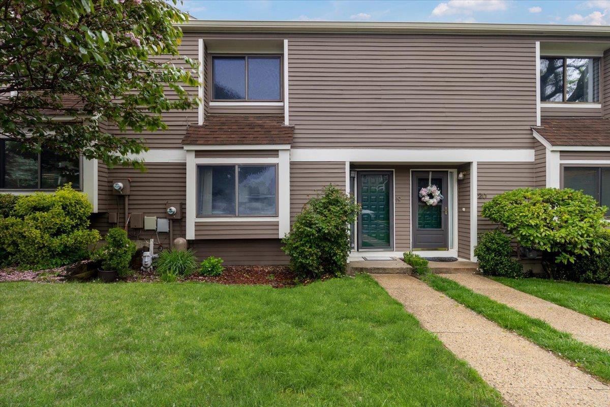 Multi unit property featuring a front lawn