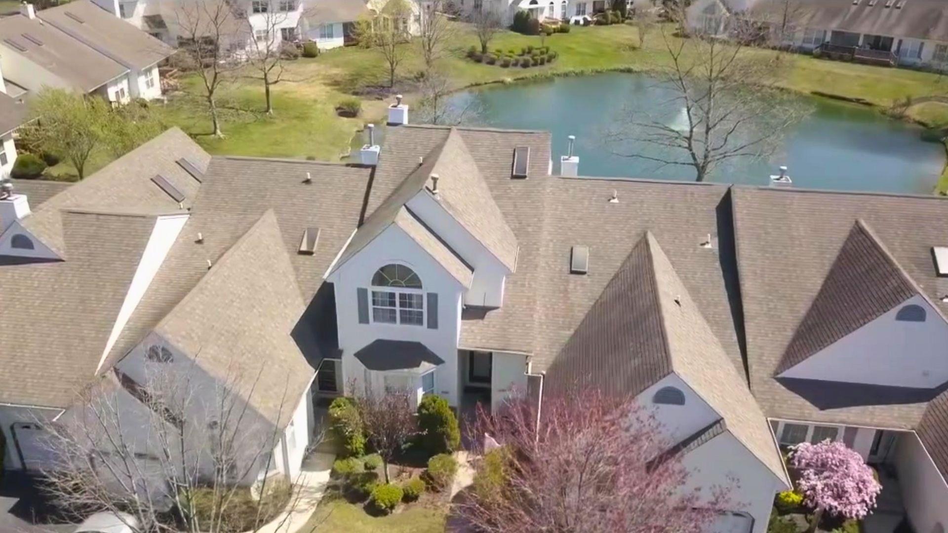 Drone / aerial view featuring a water view and a residential view