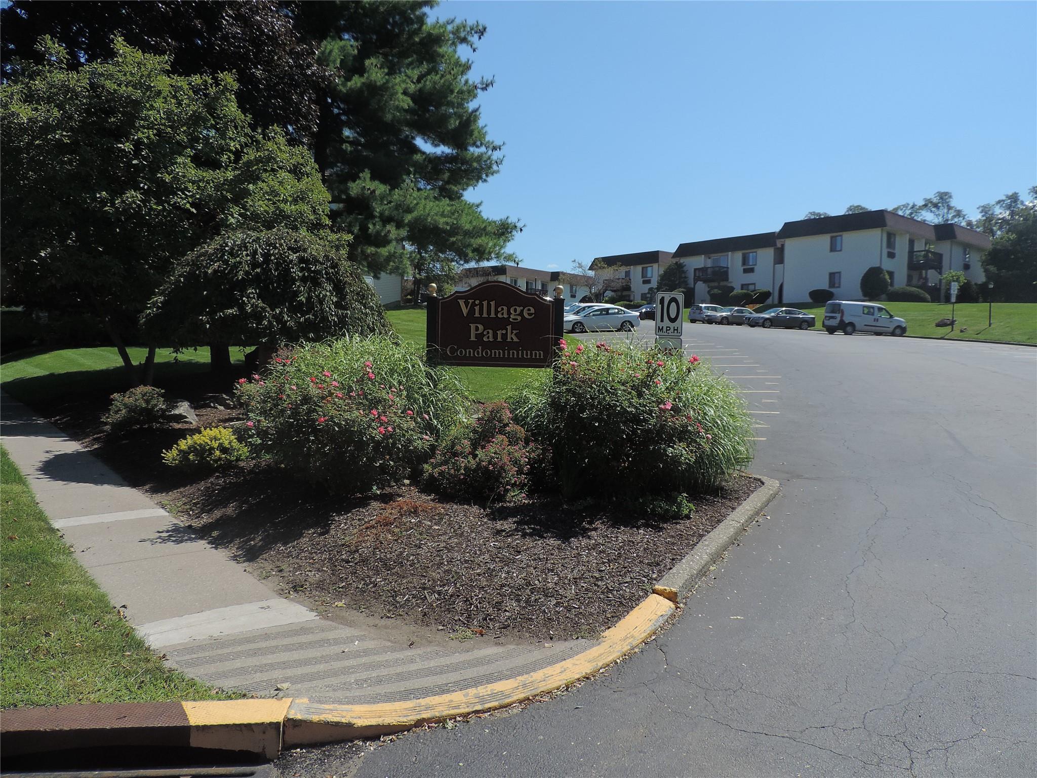 Community / neighborhood sign featuring a residential view