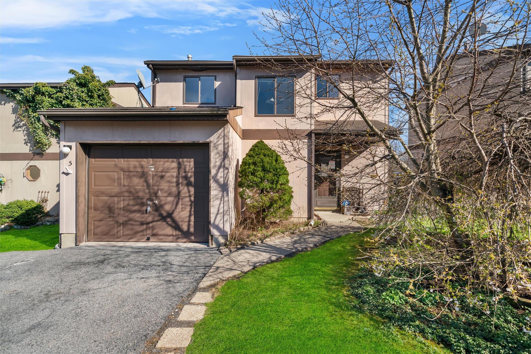 Traditional-style home featuring driveway and stucco siding