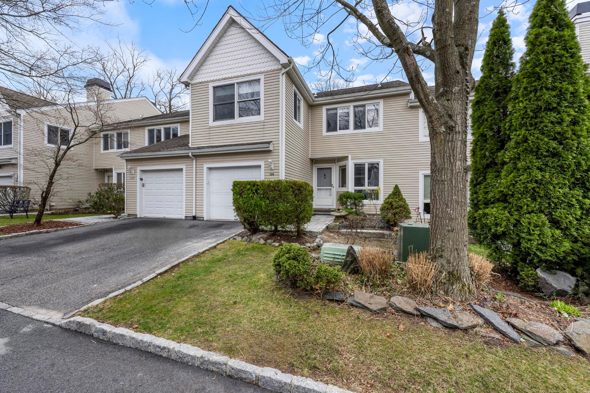 View of front of home featuring an attached garage and driveway