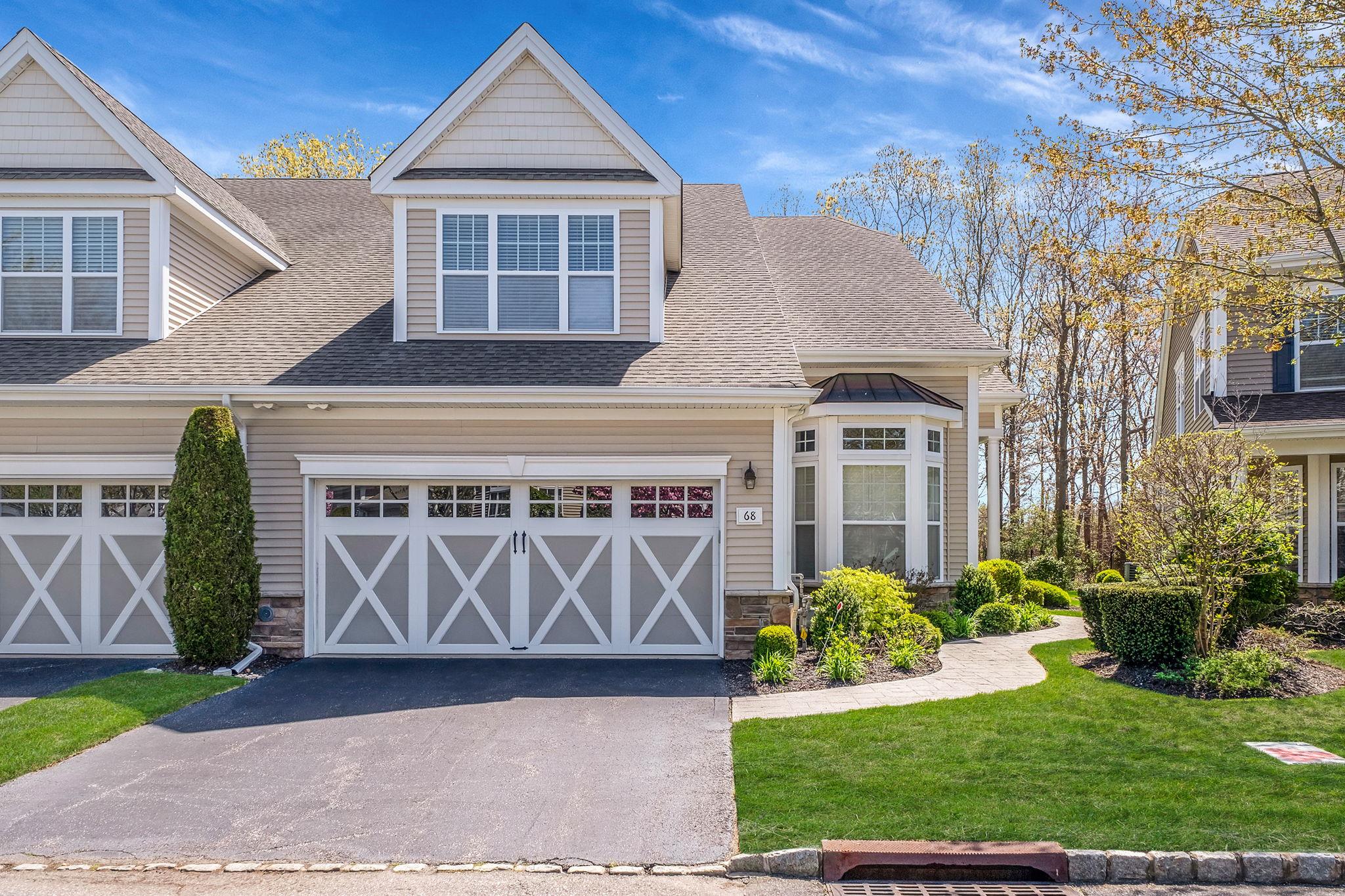Craftsman house with a shingled roof, aphalt driveway, stone siding, and a front yard