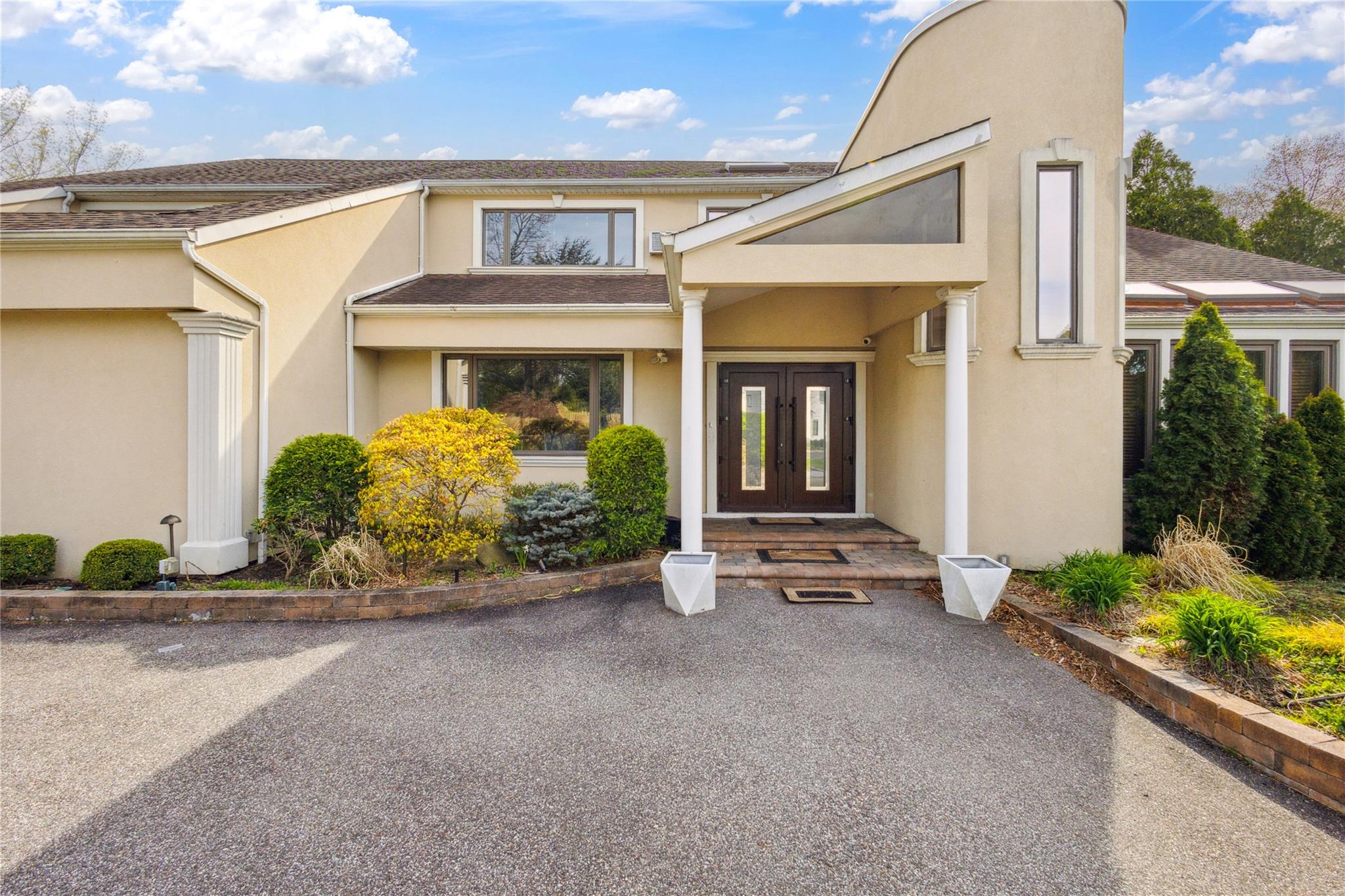 Doorway to property featuring a shingled roof, stucco siding, and french doors