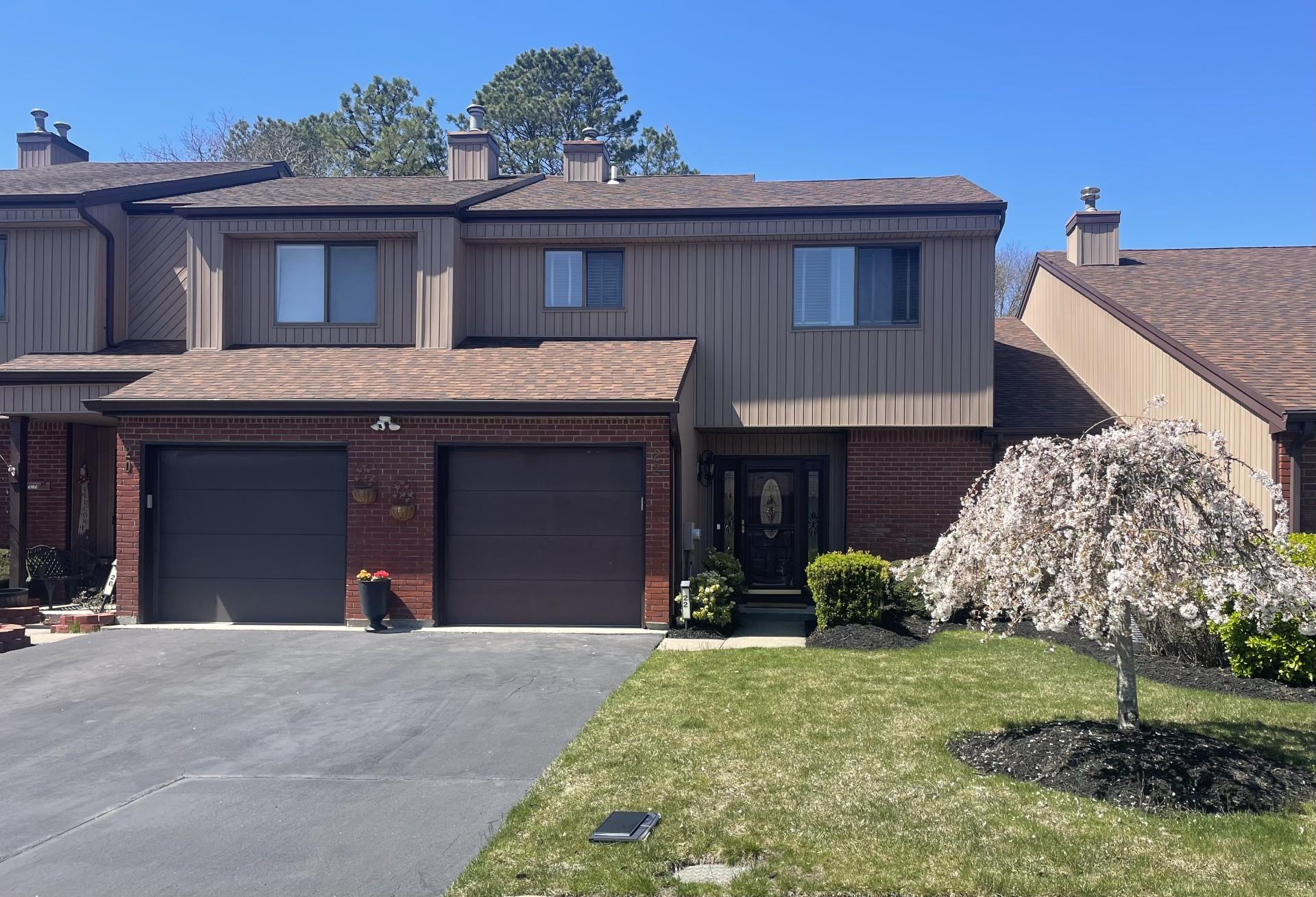 Townhouse property featuring driveway, and a garage
