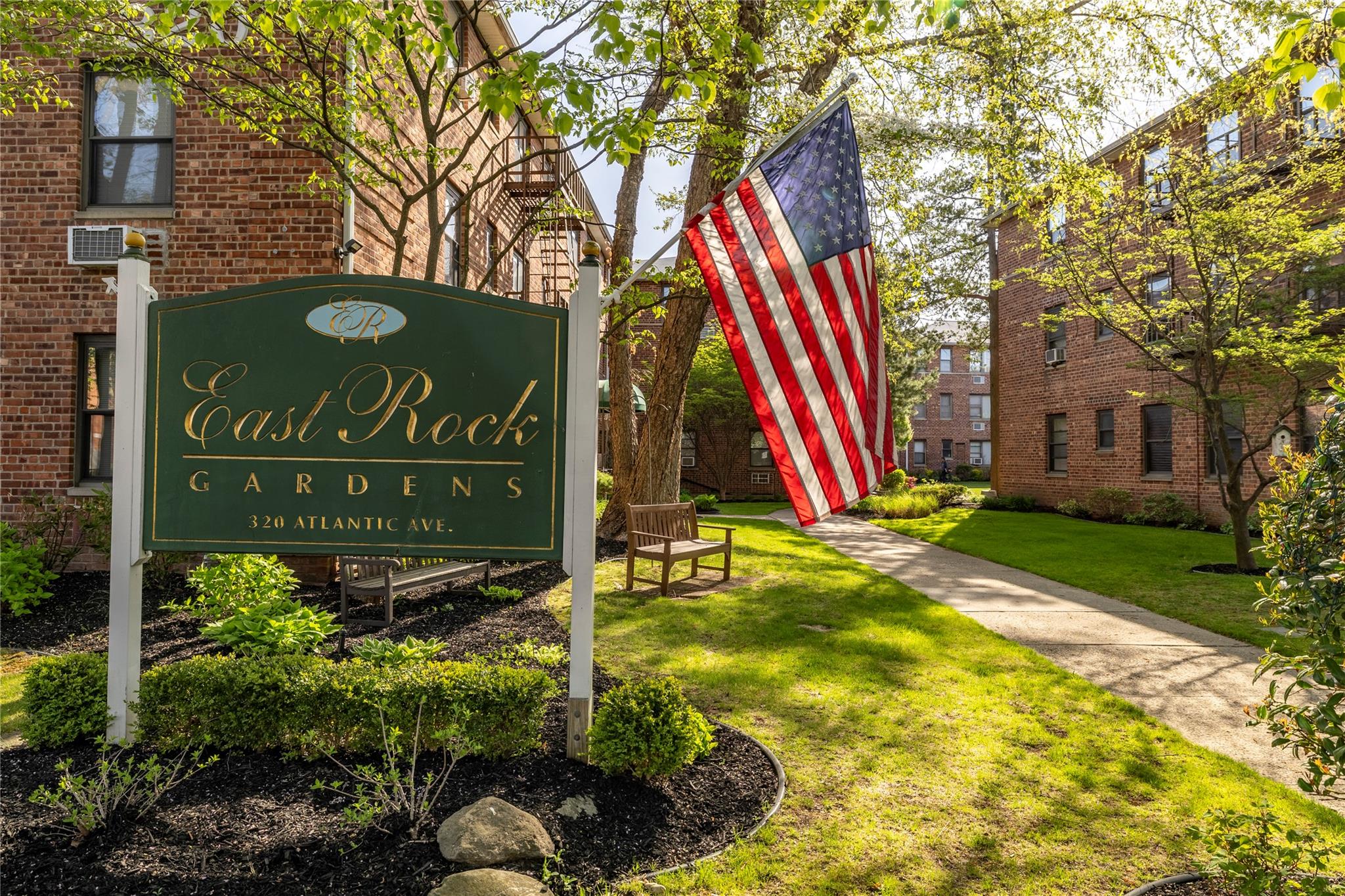 Community / neighborhood sign with a lawn
