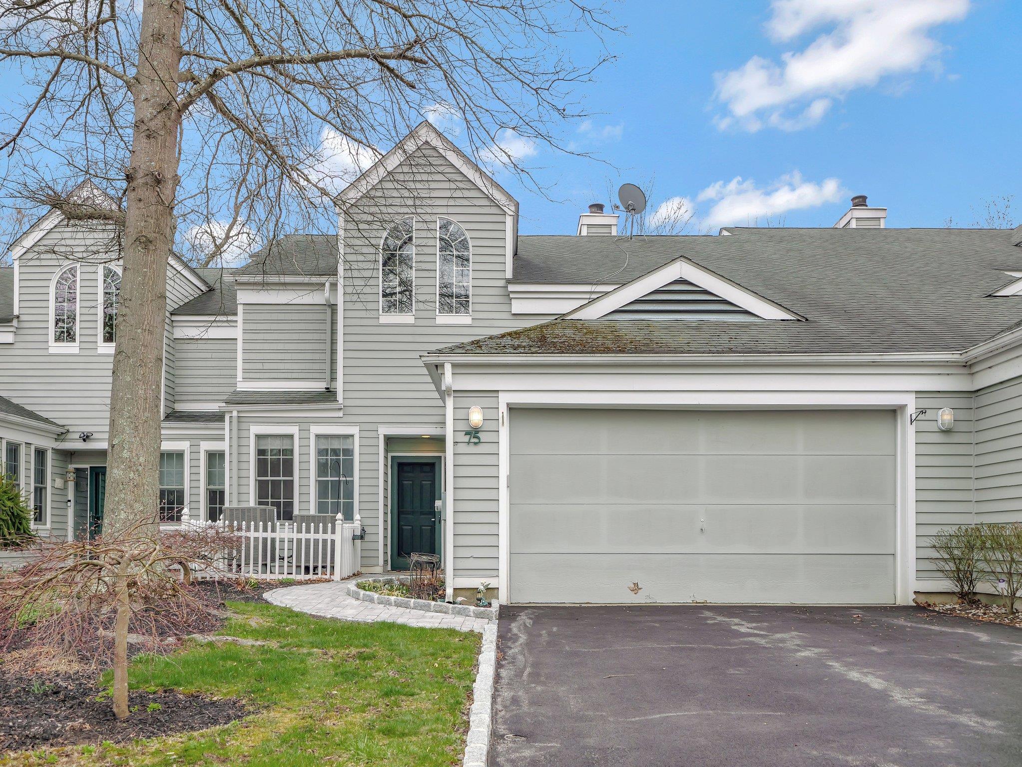 Front of townhome featuring a new driveway & new paver walkway