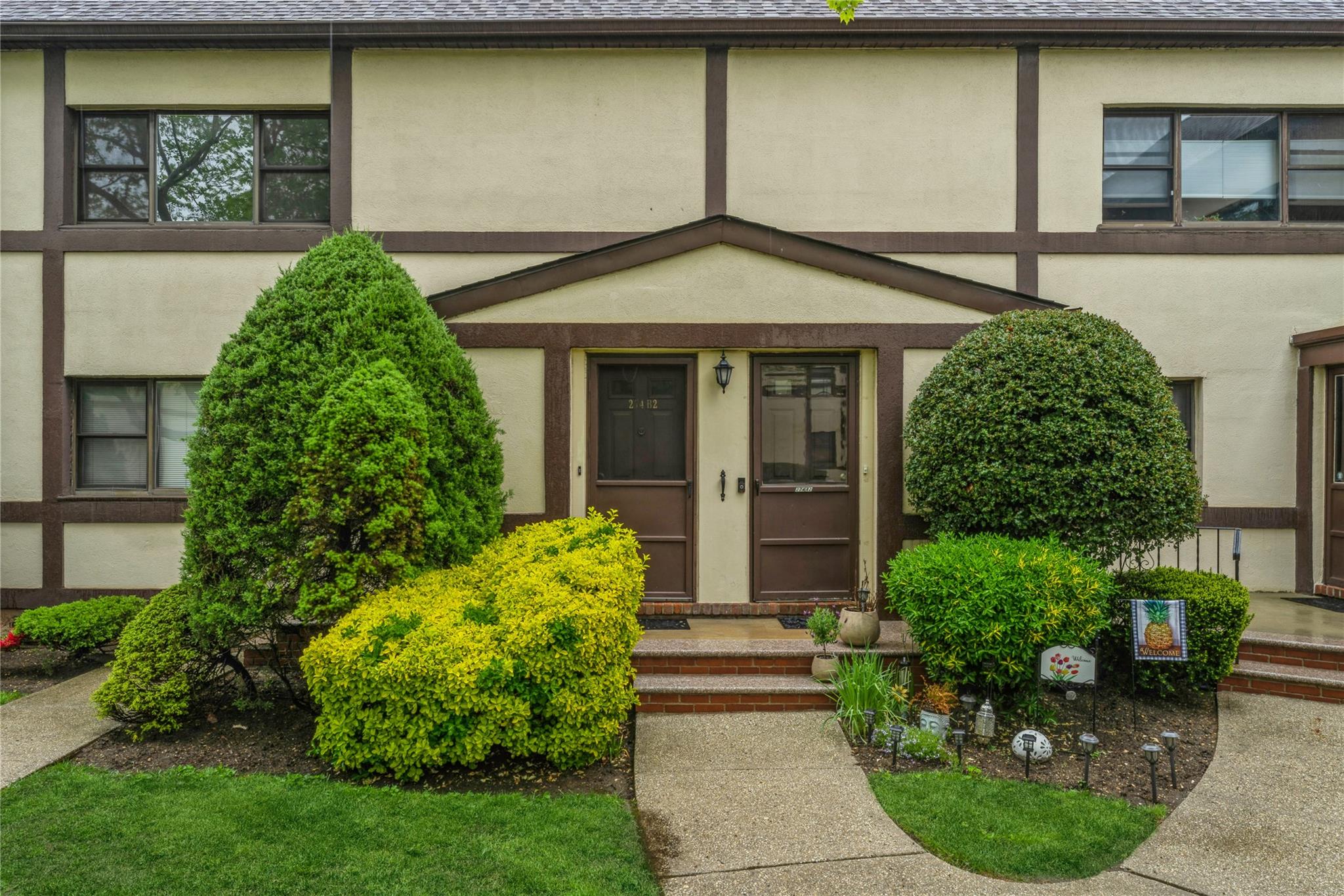 View of front of co-op with stucco siding and roof with shingles