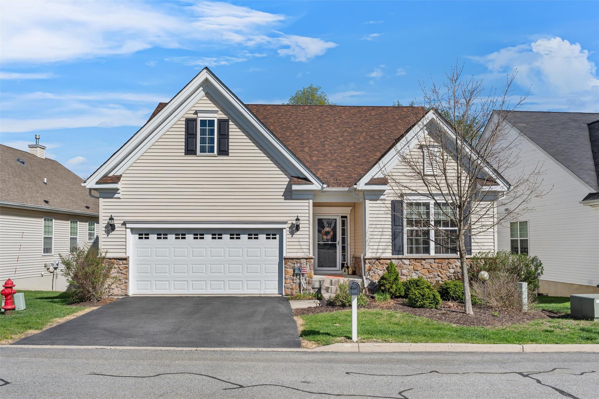 View of front of house featuring a shingled roof, a 2 car garage, and aphalt driveway