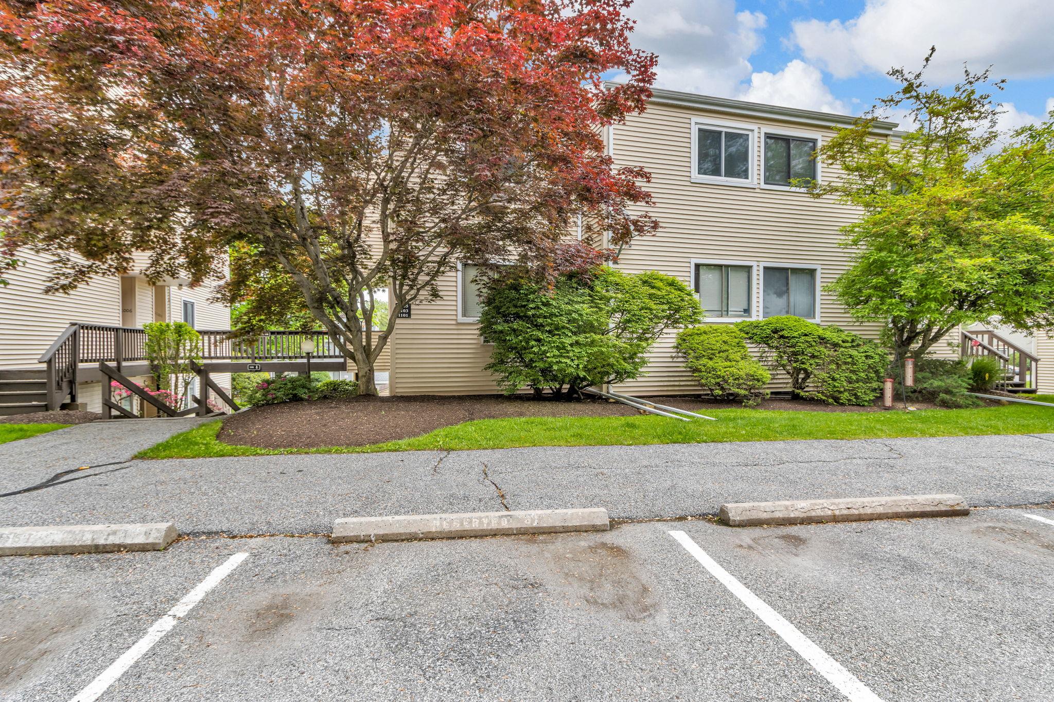 View of front of property featuring uncovered parking and stairway