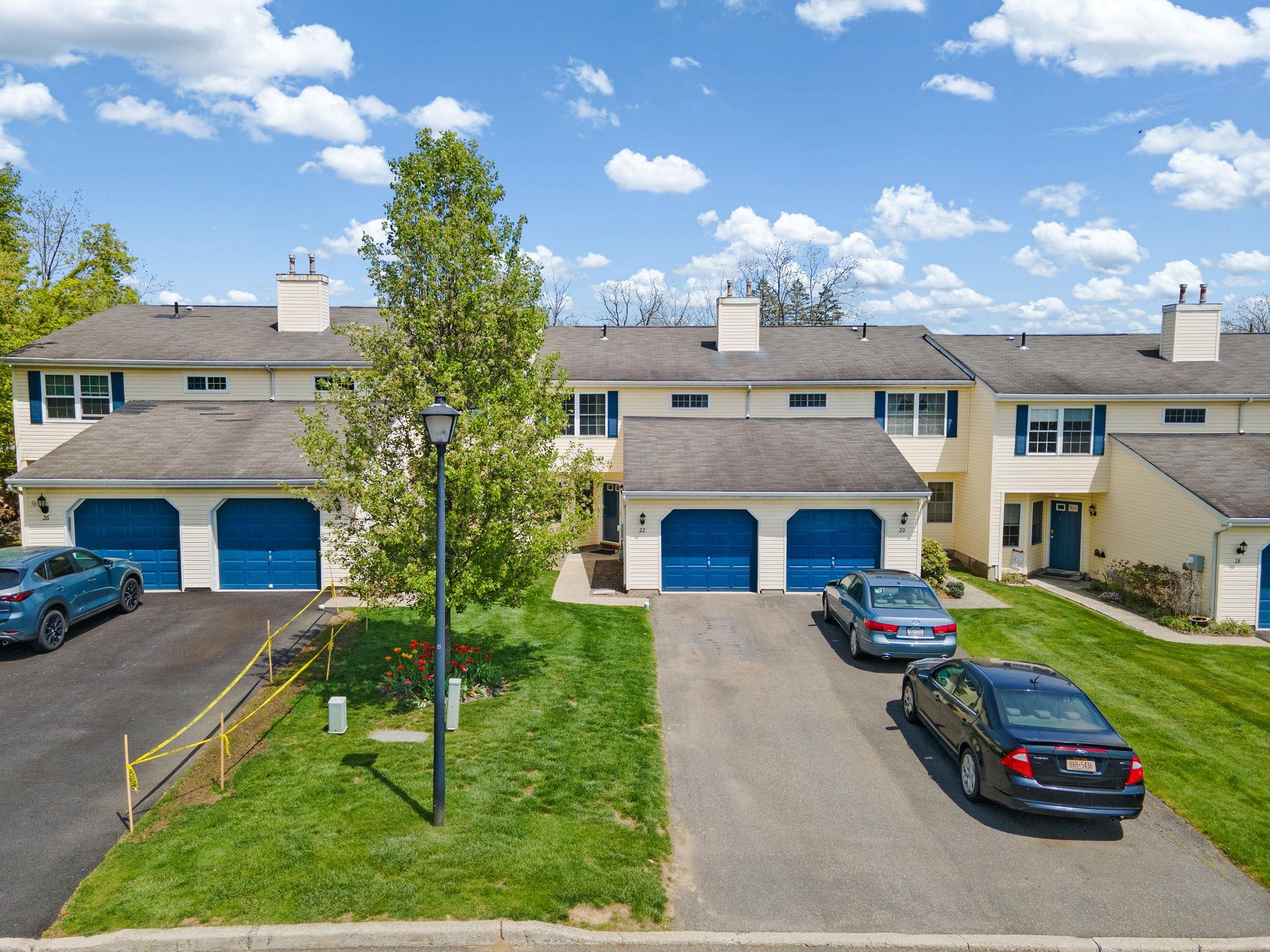View of property featuring driveway, a residential view, and a chimney