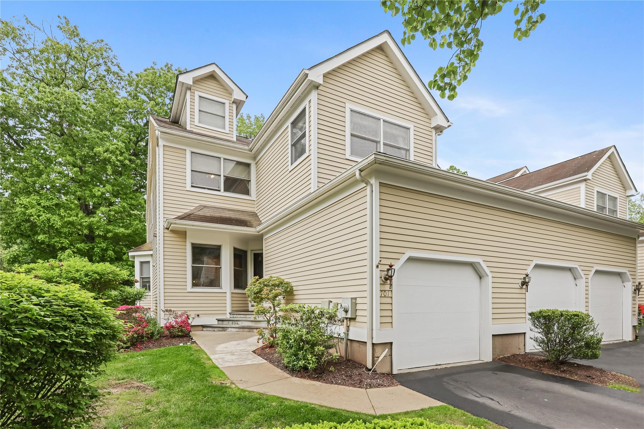 View of front of property featuring driveway and an attached garage