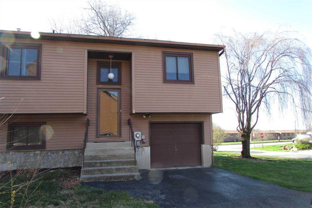 View of front facade featuring an attached garage, driveway, and entry steps