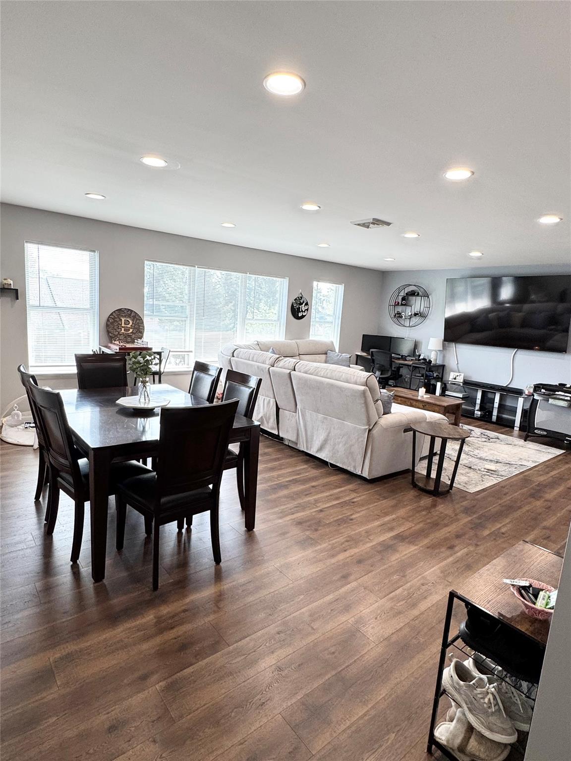 Dining area with dark wood-type flooring and recessed lighting