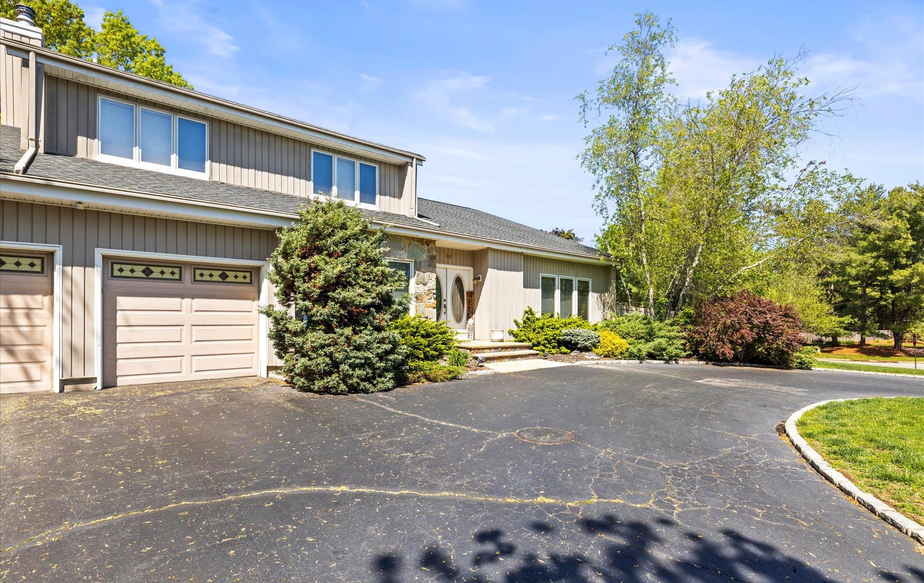 View of front of house featuring driveway and an attached garage