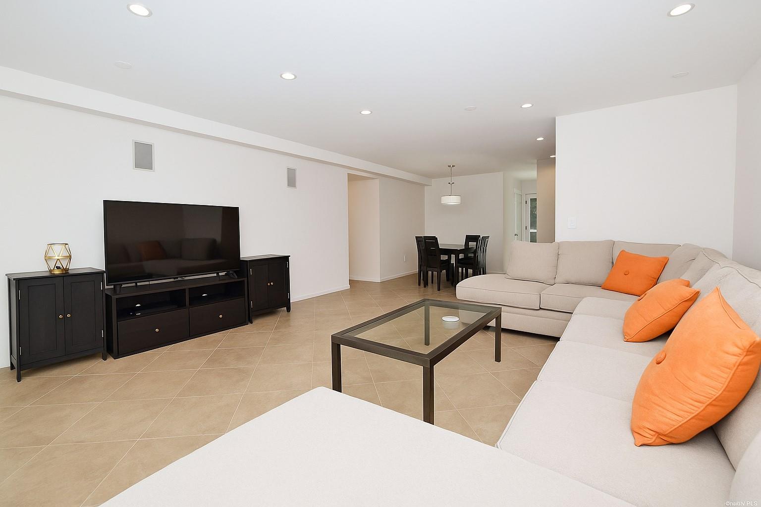 Living room featuring recessed lighting and light tile patterned floors