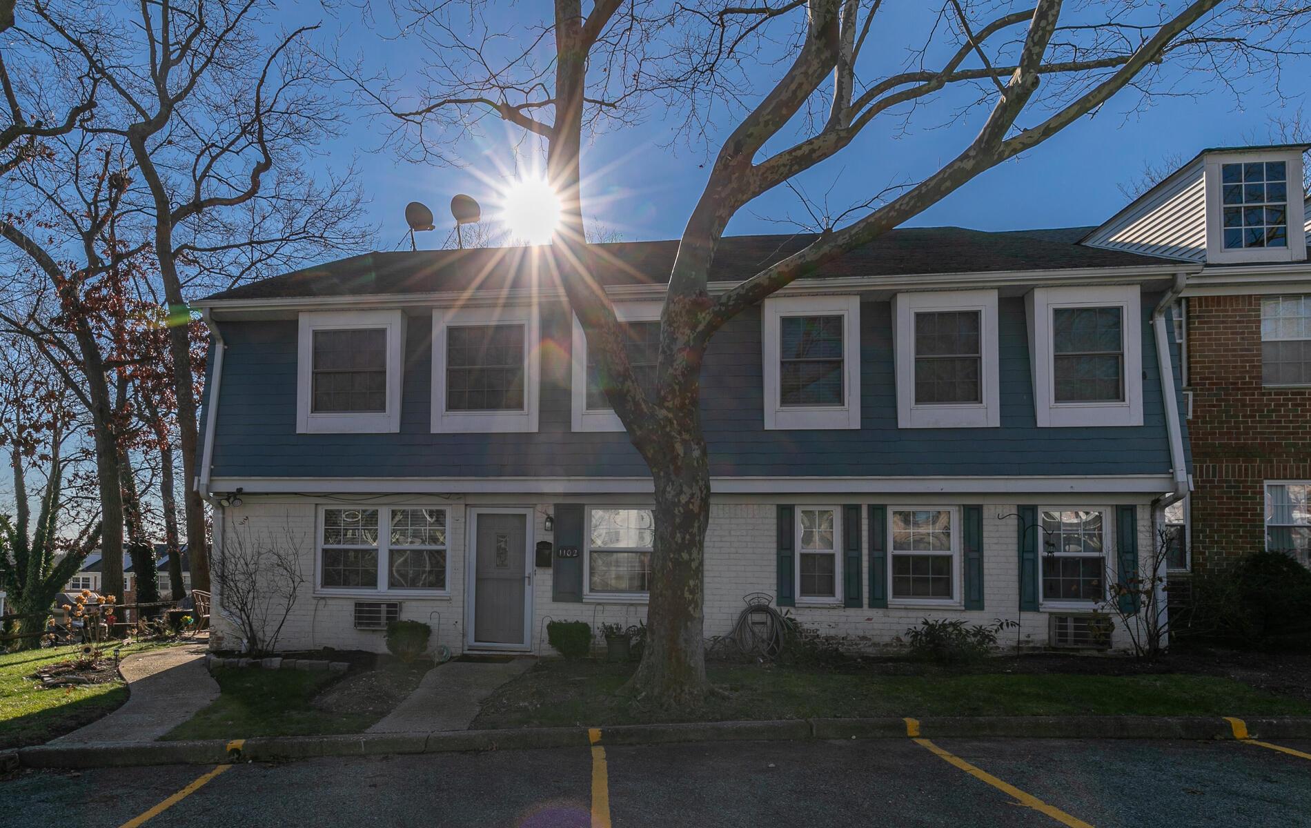 View of front of home with uncovered parking and brick siding