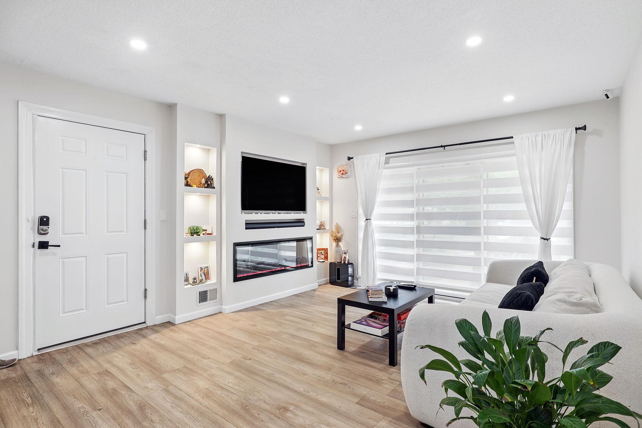 Living area with light wood-type flooring, recessed lighting, and baseboards