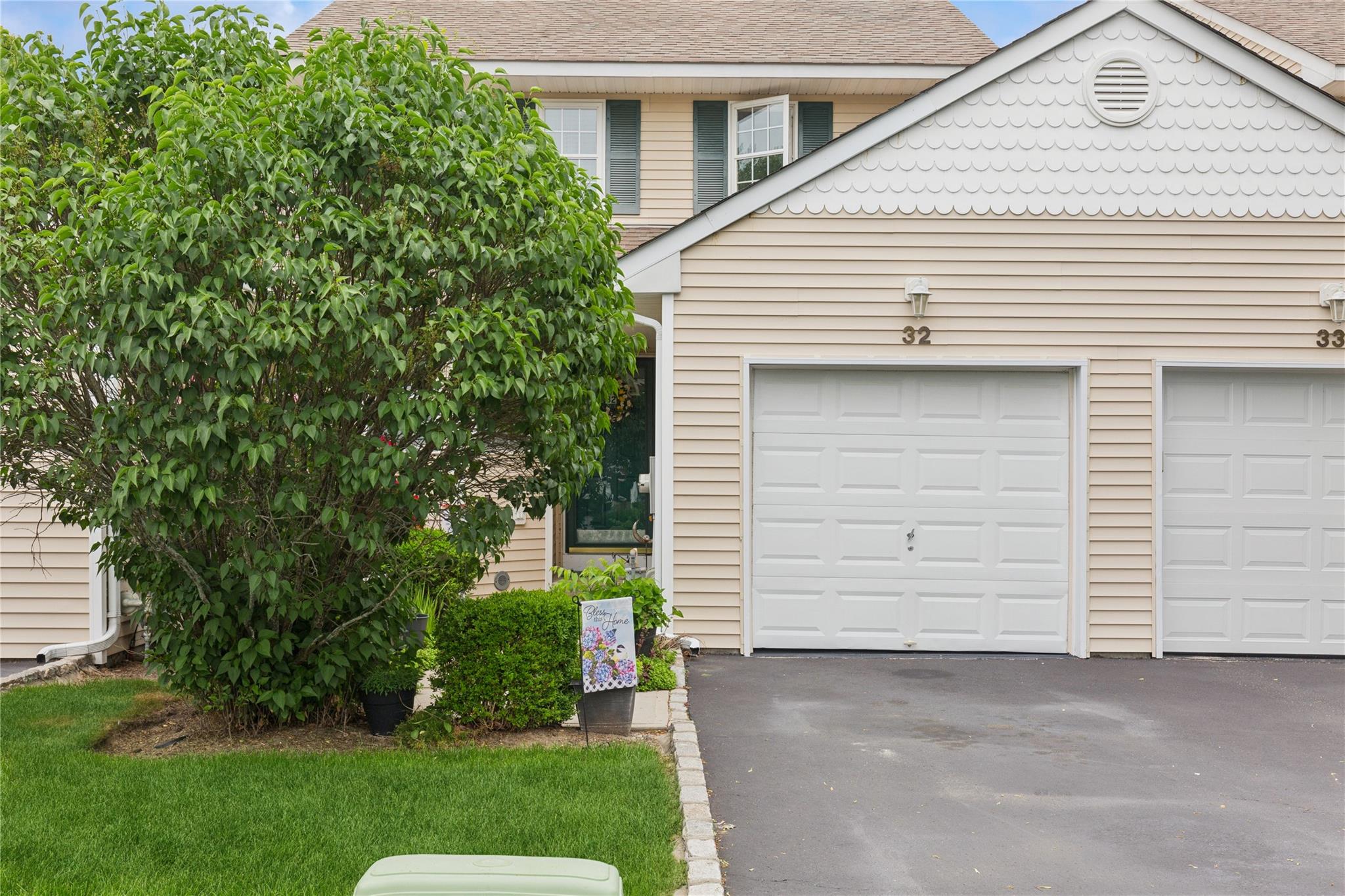 Garage featuring asphalt driveway