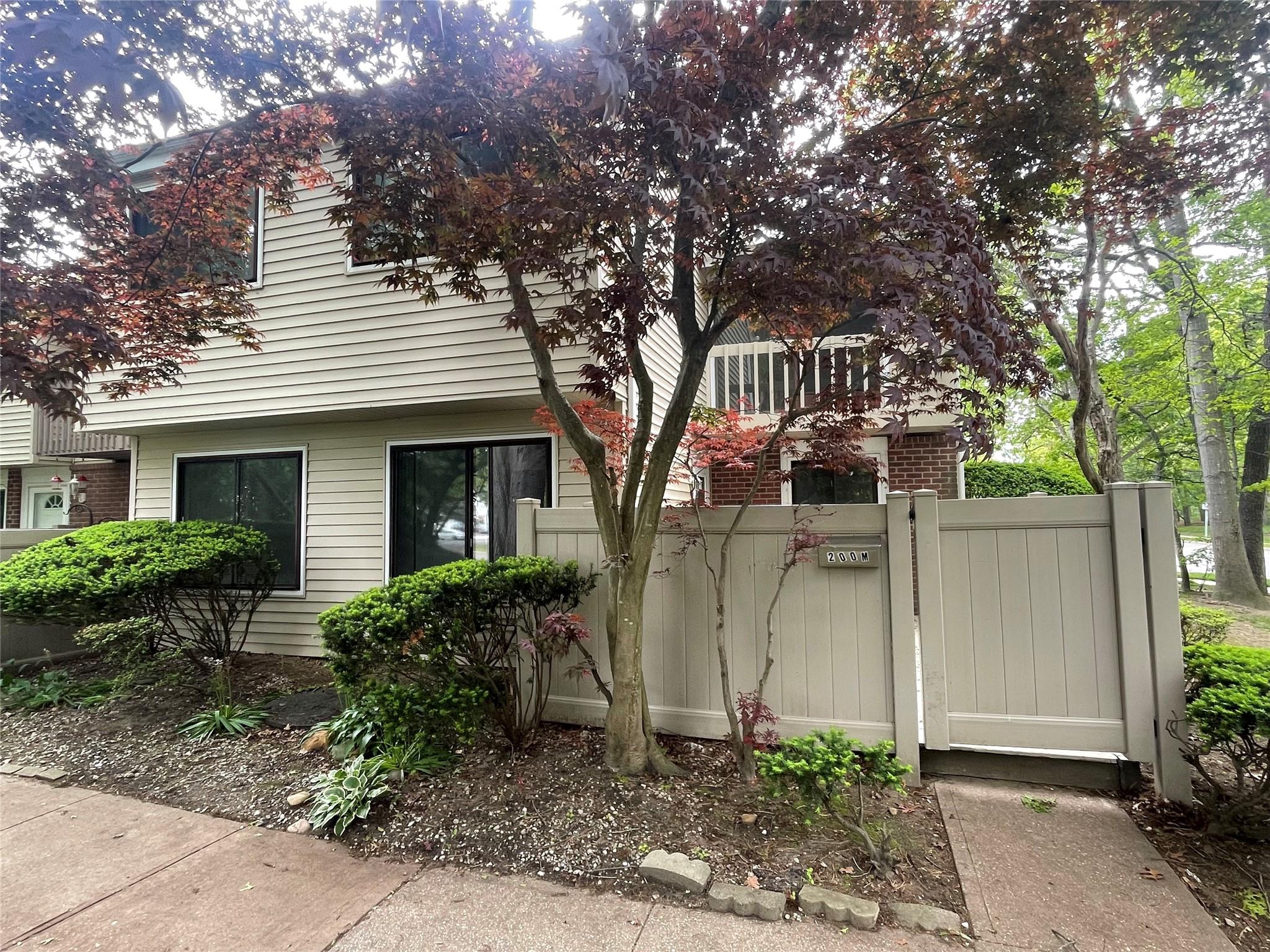 View of property exterior featuring a gate and brick siding
