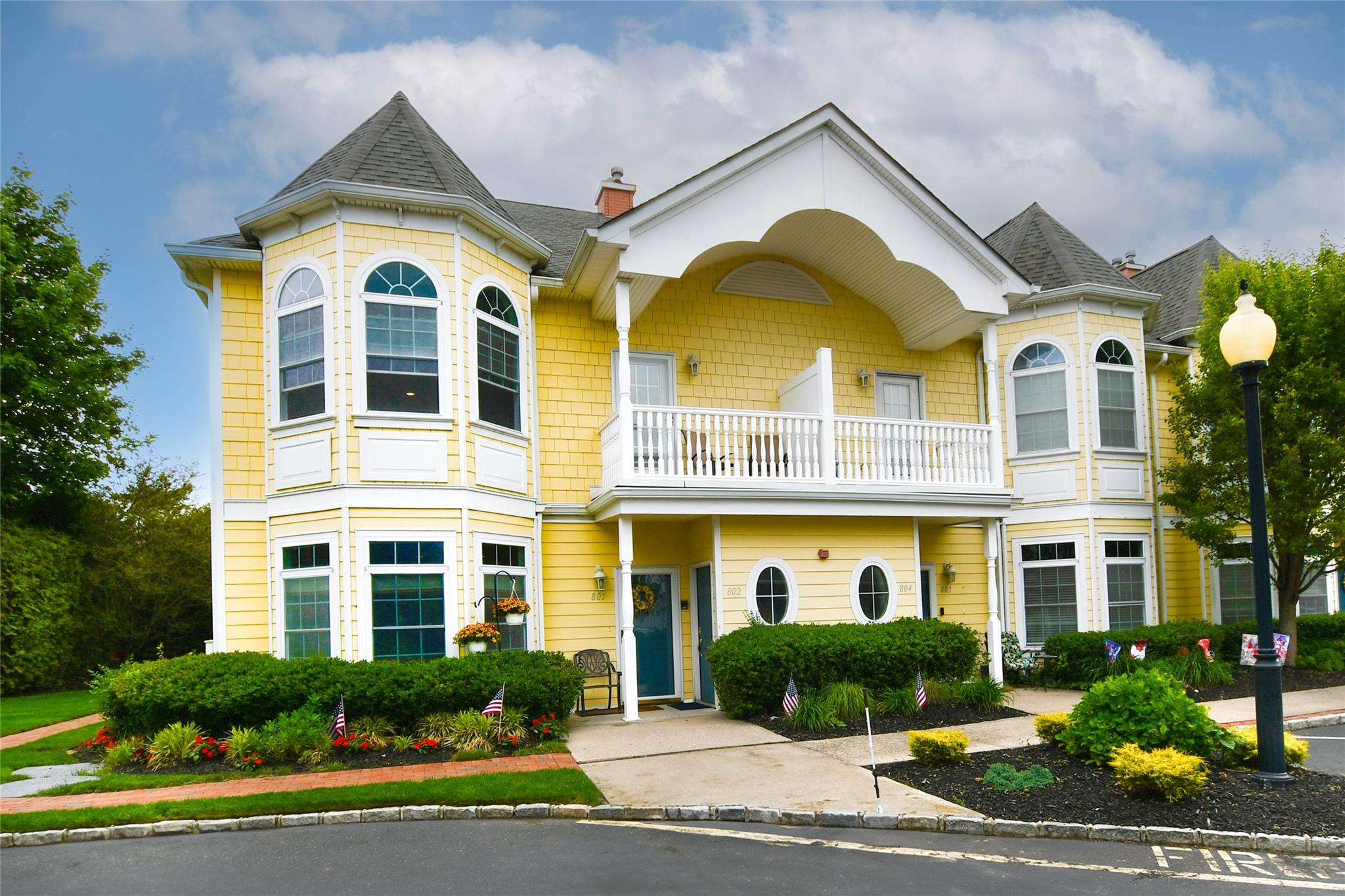 Victorian home with a balcony, a chimney, and a shingled roof