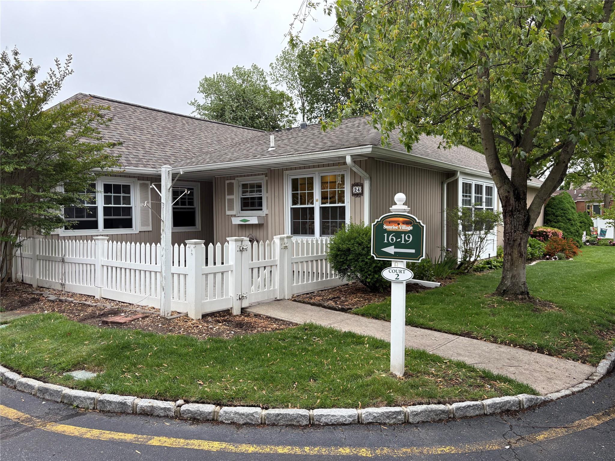 Ranch-style house featuring roof with shingles