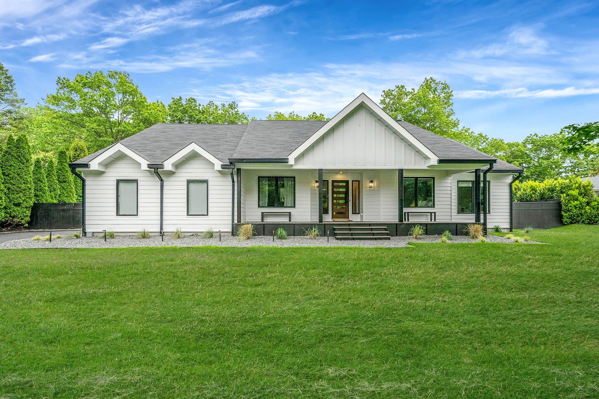 Modern inspired farmhouse with board and batten siding and covered porch
