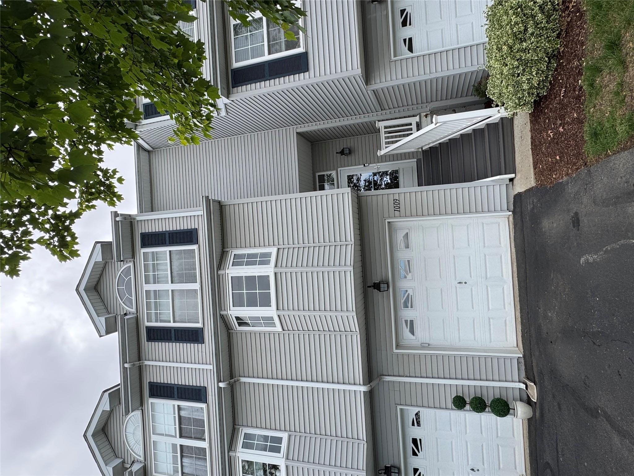Townhome / multi-family property featuring an attached garage and driveway