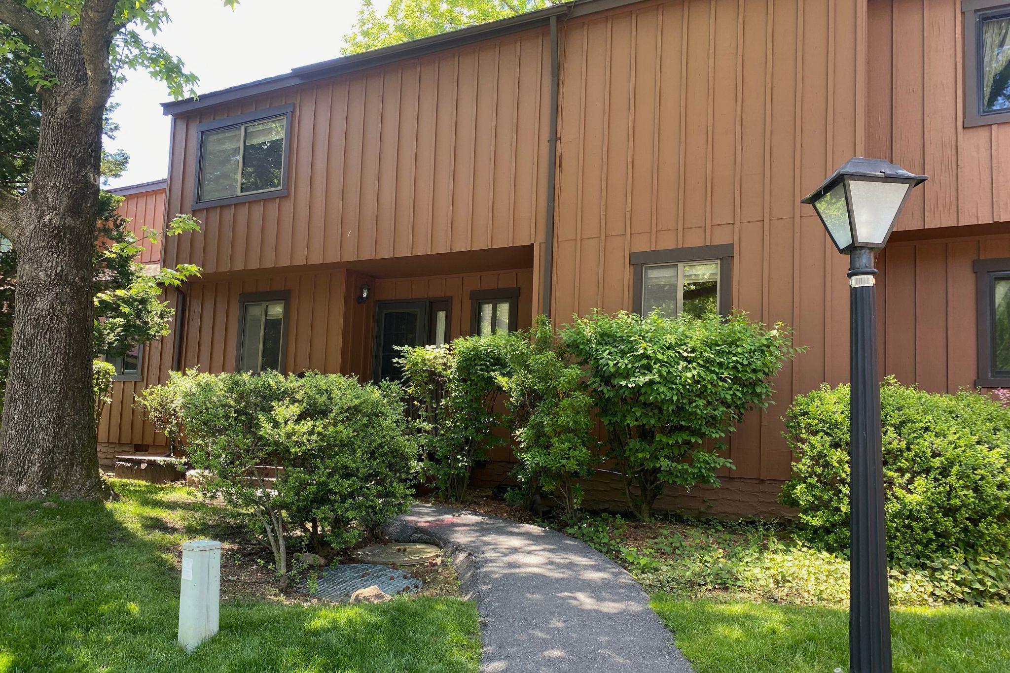 View of front of house with board and batten siding and a front yard