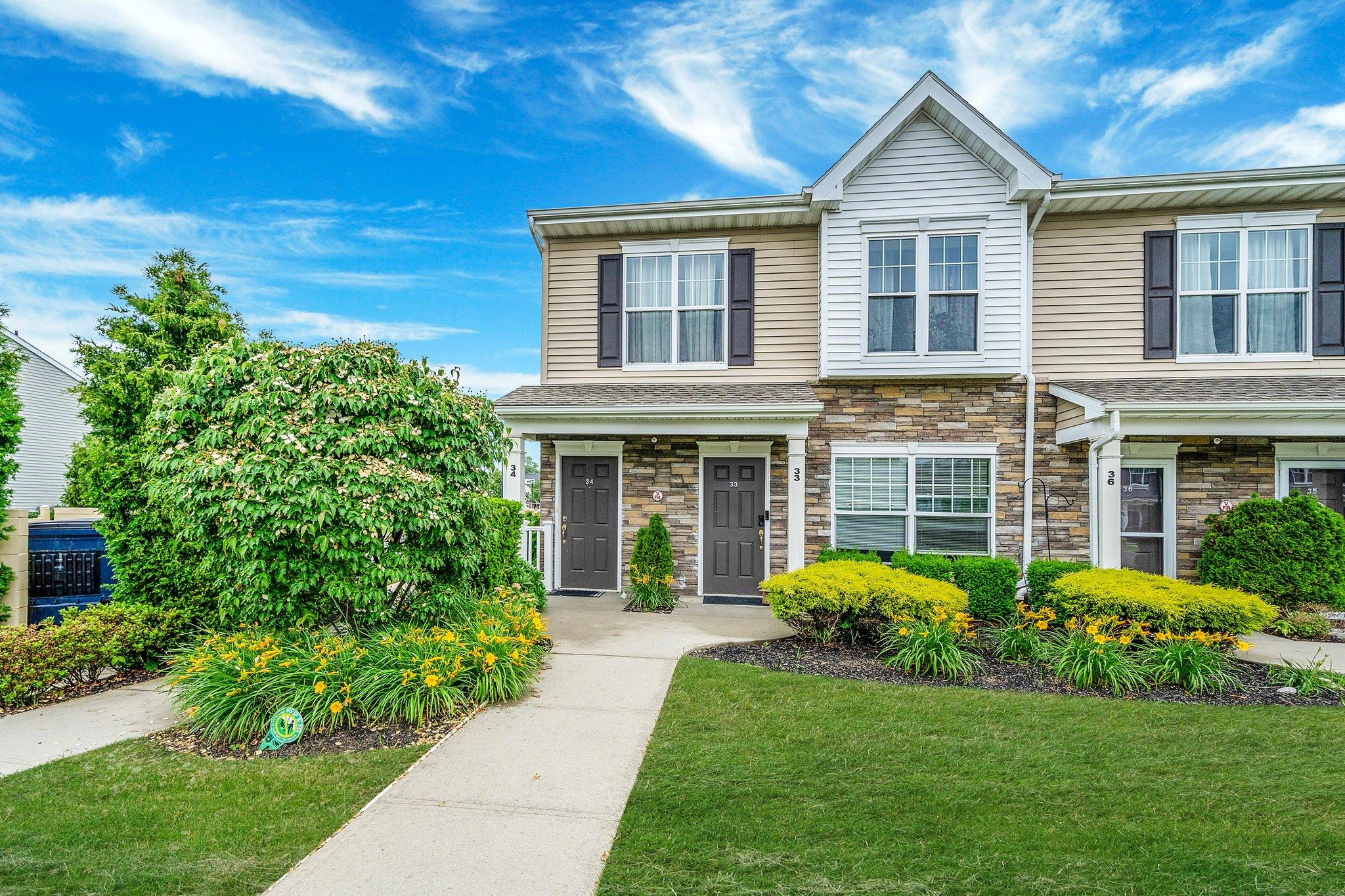 View of front of property with stone siding and a front yard