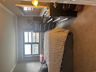 Bedroom with carpet, crown molding, and multiple windows