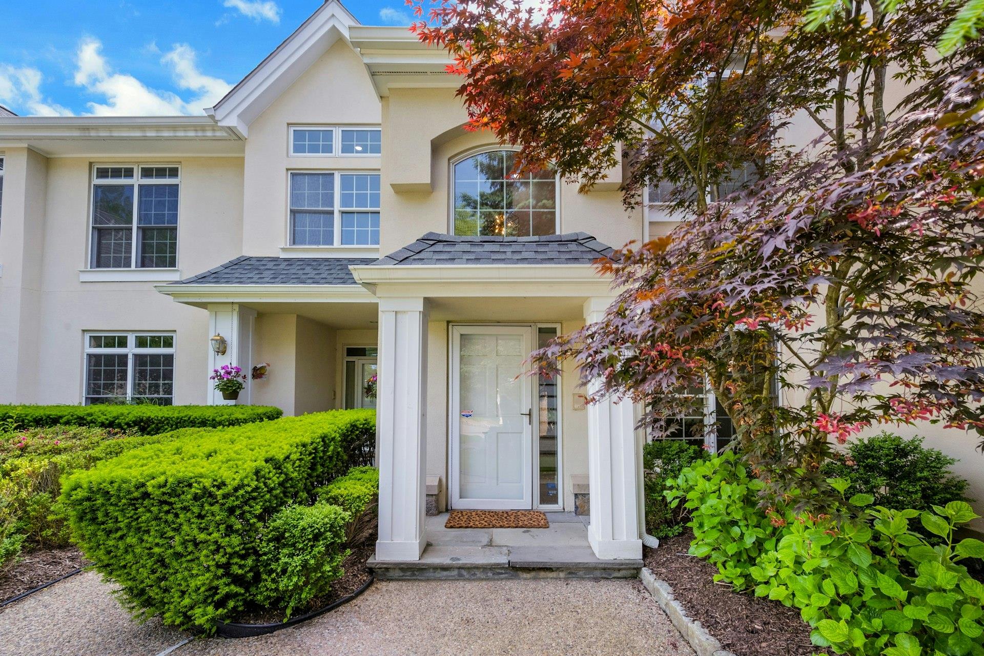 Property entrance featuring stucco siding and roof with shingles