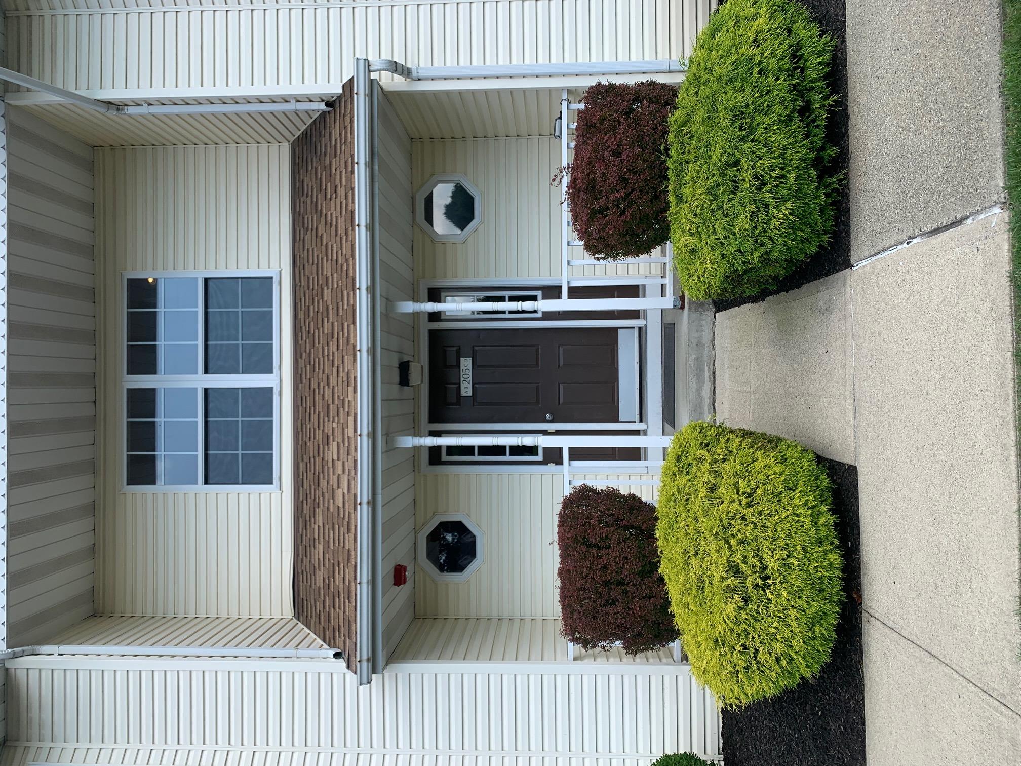 Main entrance to property featuring covered porch