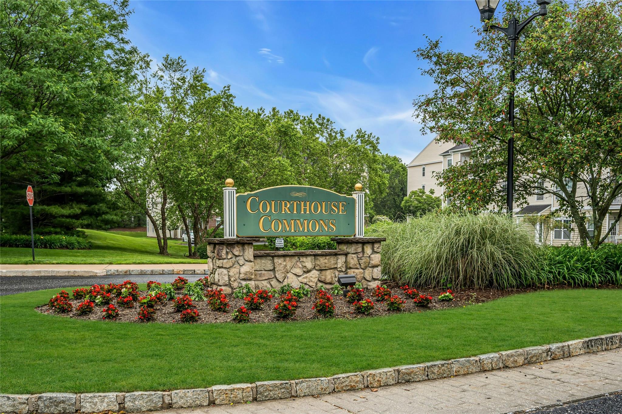 Community / neighborhood sign featuring a yard