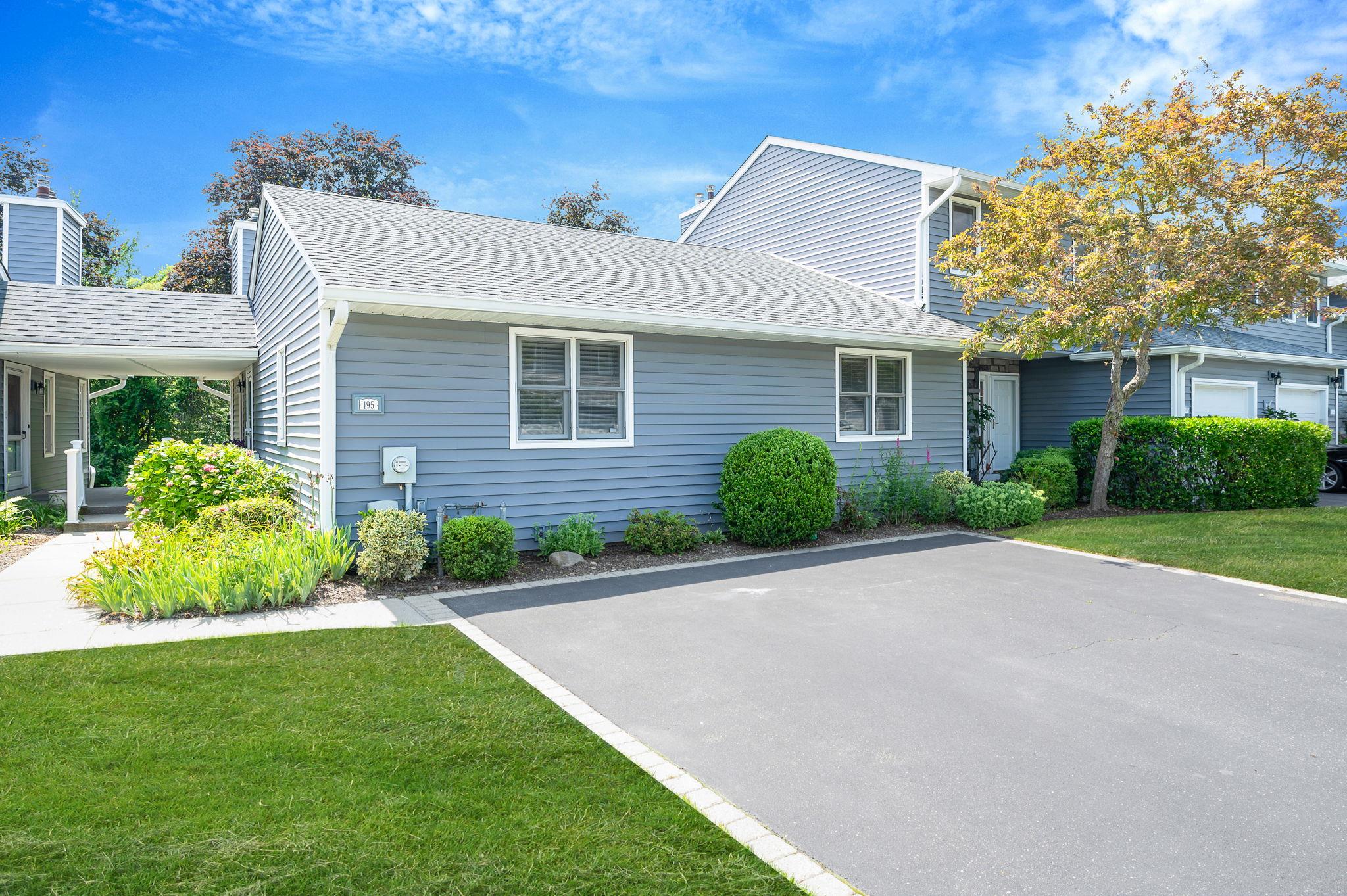View of home's exterior featuring a lawn and roof with shingles