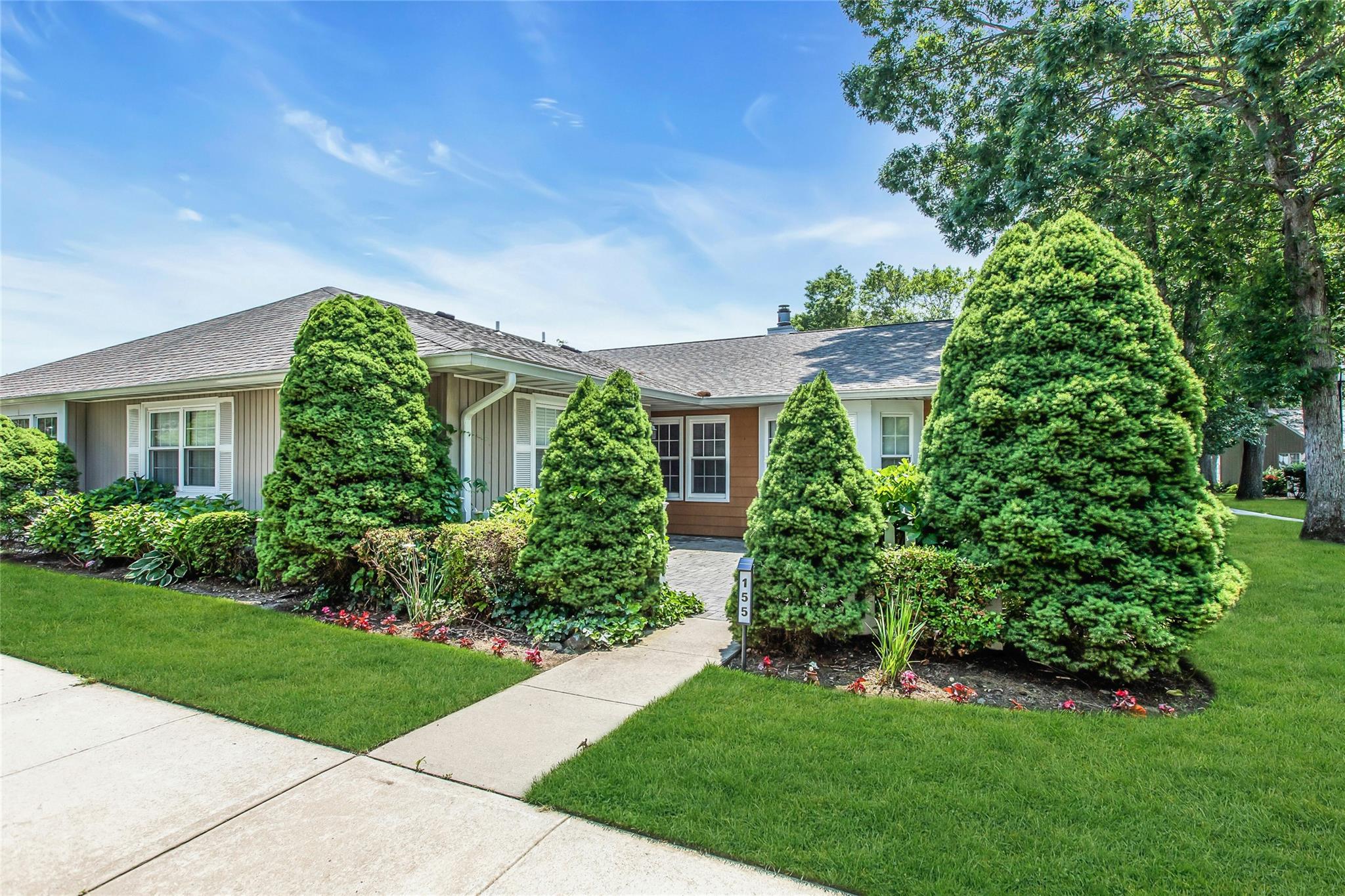 Ranch-style house featuring a front yard and roof with shingles