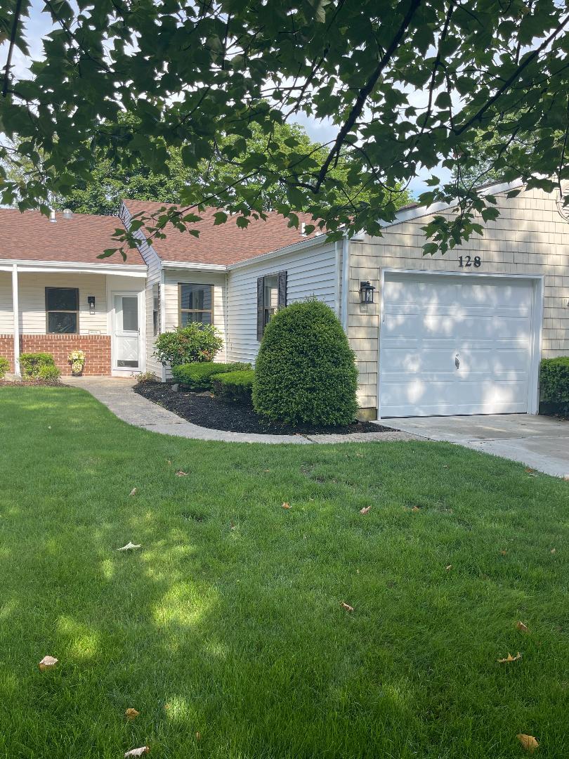Single story home with a front lawn and concrete driveway