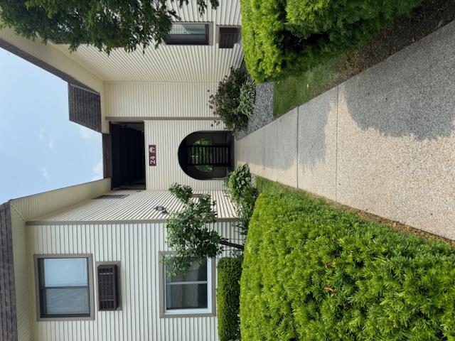 Entrance to property featuring a shingled roof
