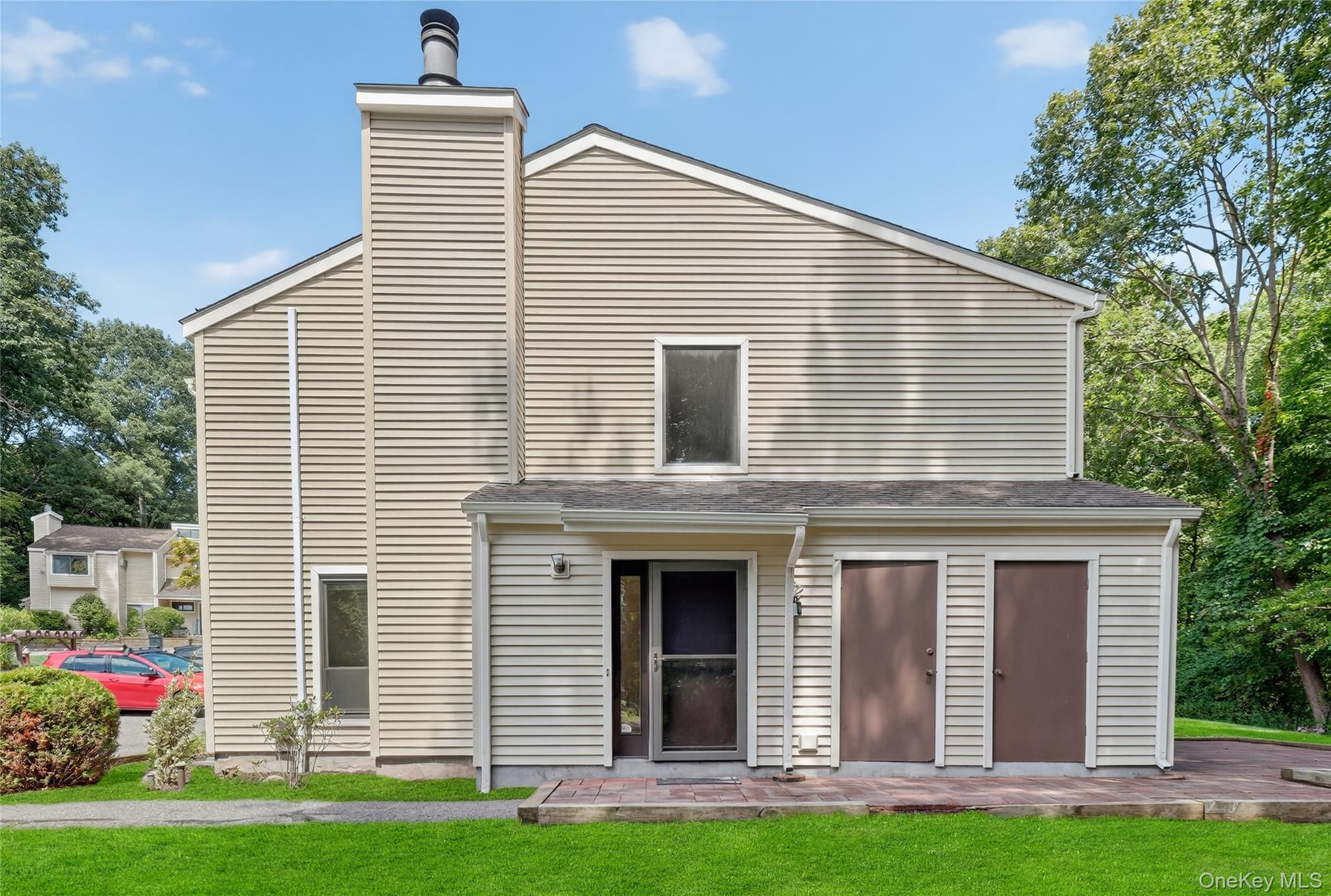 Rear view of property with a yard and a chimney