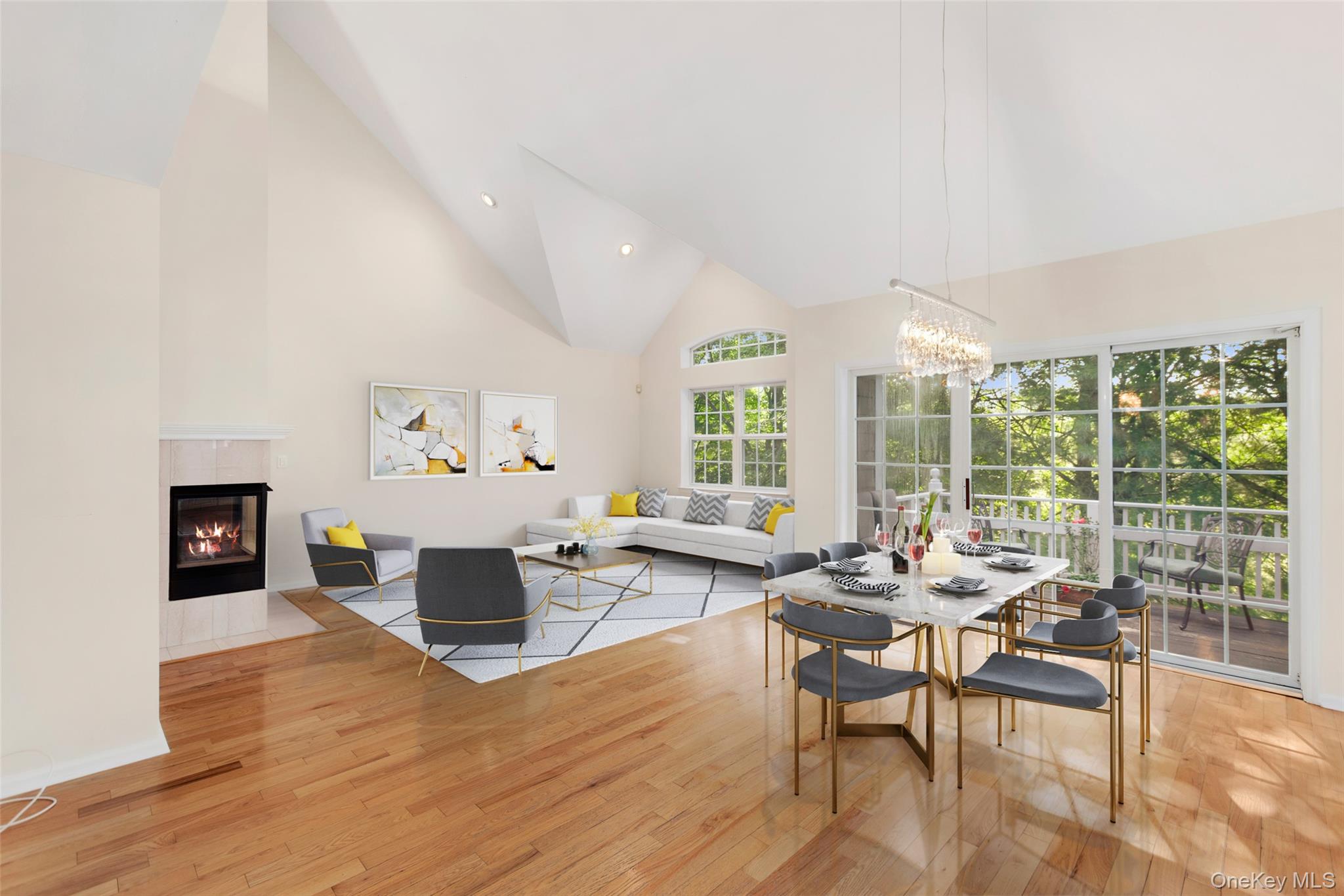 An open floor plan, living room, and formal dining area with stunning vaulted ceilings, a turn-on gas fireplace. A great space for entertaining family and friends.-- Virtually Staged