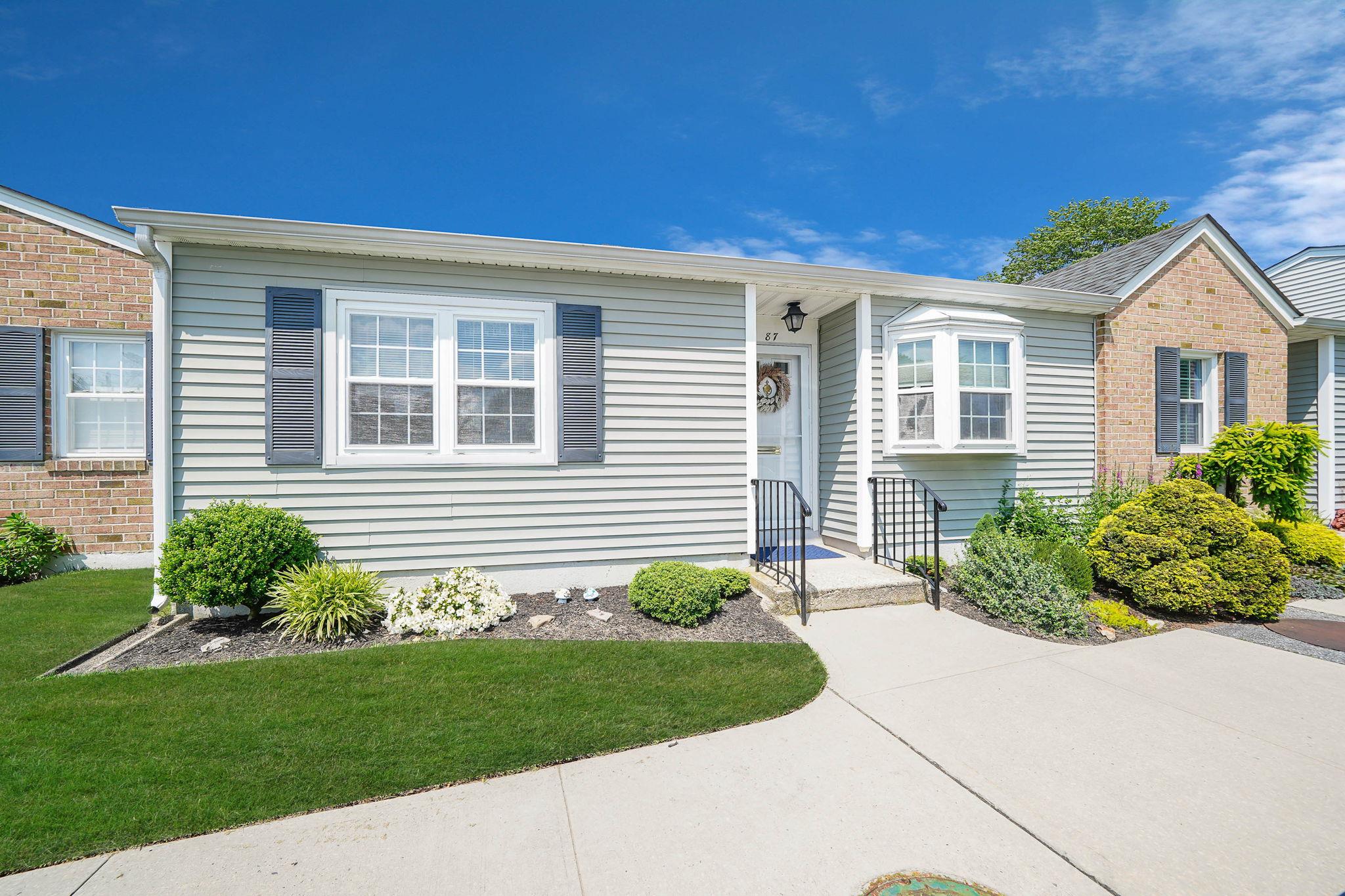 View of front facade with a front yard and brick siding