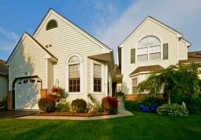 An attached garage with private driveway and covered entrance